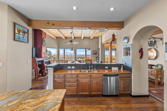 kitchen with dishwasher, dark wood-type flooring, sink, ceiling fan, and beam ceiling