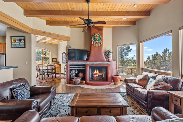 living room featuring hardwood / wood-style flooring, ceiling fan, wood ceiling, and beamed ceiling