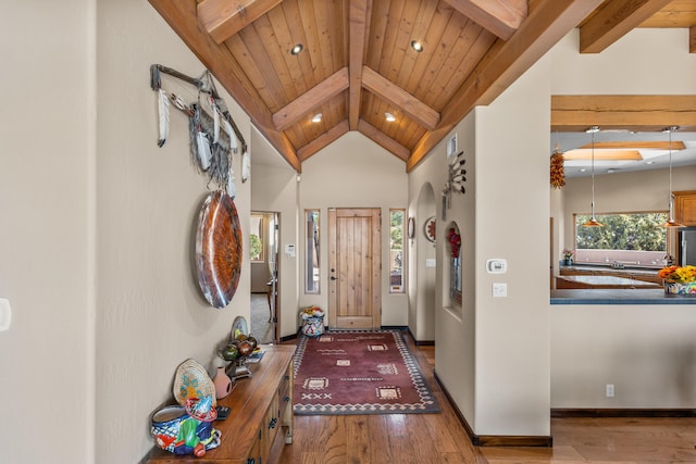 entrance foyer featuring hardwood / wood-style flooring, wood ceiling, beamed ceiling, and high vaulted ceiling