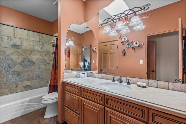 full bathroom featuring vanity, shower / bath combination with curtain, and toilet