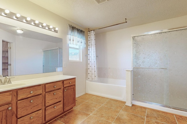 bathroom with tile patterned flooring, vanity, a textured ceiling, and shower with separate bathtub