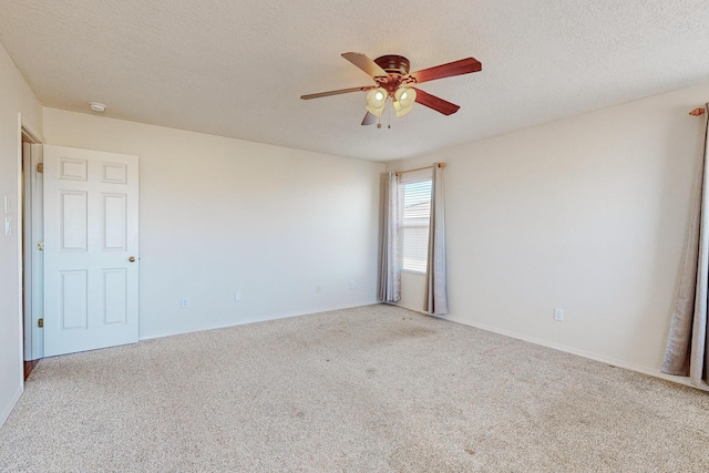 unfurnished room with ceiling fan, carpet floors, and a textured ceiling