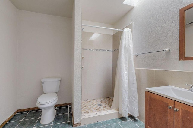 bathroom with curtained shower, tile patterned flooring, vanity, and toilet