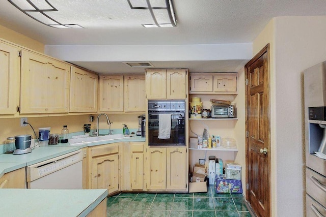 kitchen featuring black oven, dishwasher, light brown cabinets, and sink