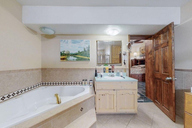 bathroom featuring vanity, tiled bath, and tile patterned floors