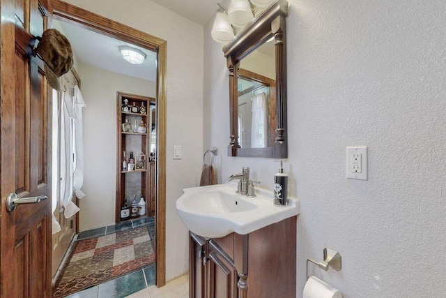 bathroom with tile patterned flooring and vanity