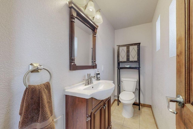 bathroom with tile patterned floors, vanity, and toilet