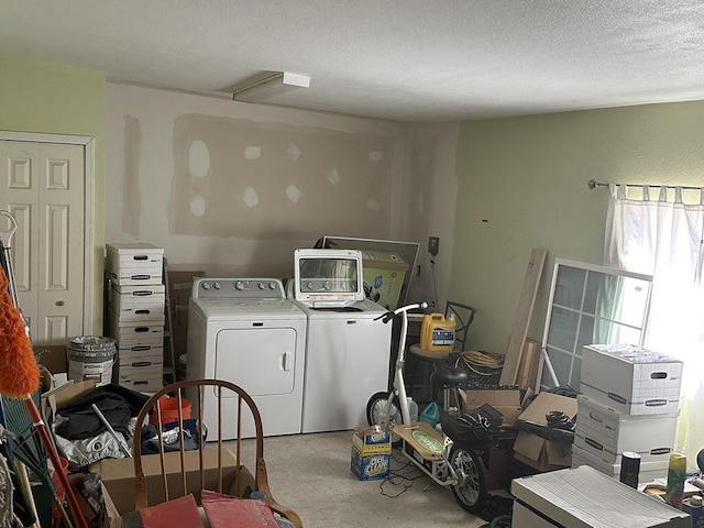 laundry area with a textured ceiling and separate washer and dryer