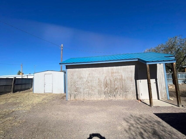 view of shed with fence