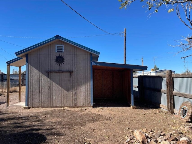 view of outdoor structure with an outbuilding and fence