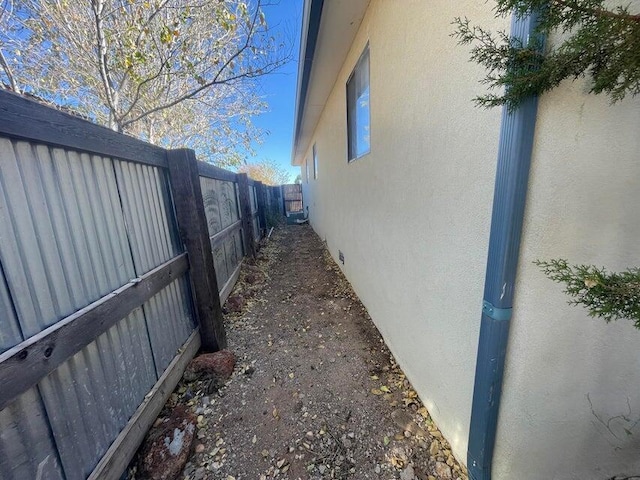 view of home's exterior with stucco siding and a fenced backyard