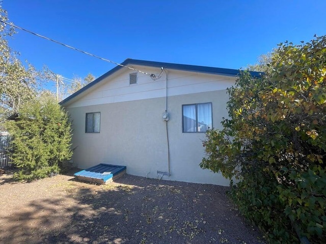 view of side of property featuring stucco siding