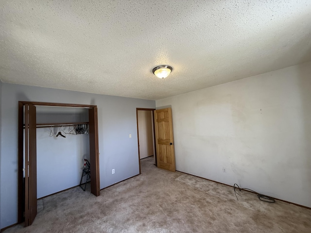 unfurnished bedroom with a closet, carpet floors, and a textured ceiling