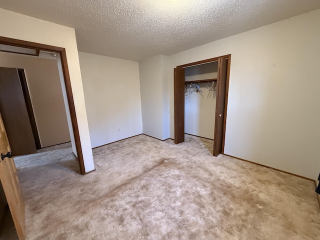 unfurnished bedroom with a textured ceiling and carpet flooring