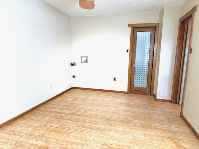 empty room with a textured ceiling, light hardwood / wood-style floors, and ceiling fan