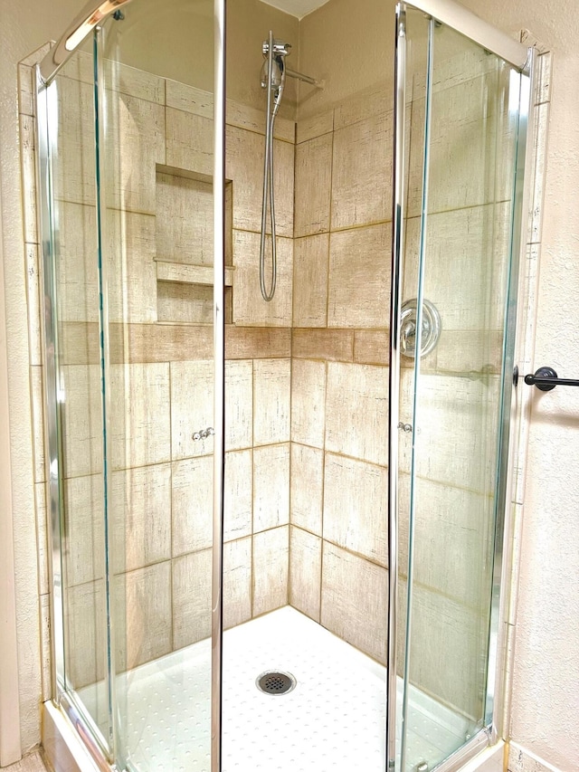 bathroom with a shower with shower door