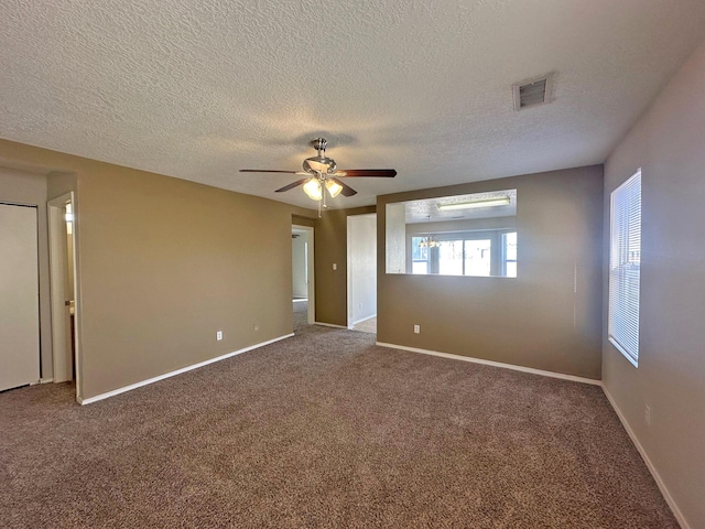 empty room featuring a textured ceiling, carpet floors, and ceiling fan