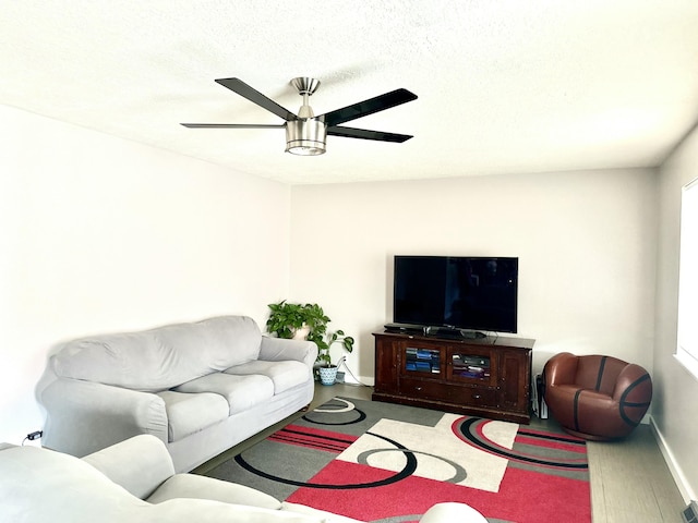 living room featuring ceiling fan and a healthy amount of sunlight