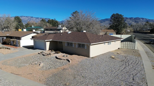 view of home's exterior featuring a mountain view and a garage