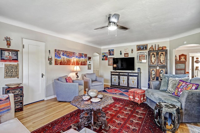 living room featuring hardwood / wood-style floors and ceiling fan