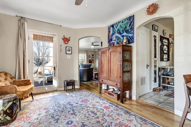 living area with ceiling fan and wood-type flooring