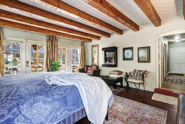 bedroom featuring dark hardwood / wood-style floors, beam ceiling, and french doors