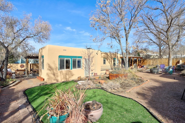 rear view of house with a lawn and a patio area