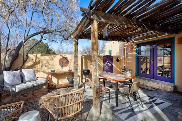 view of patio featuring outdoor lounge area, a pergola, and french doors