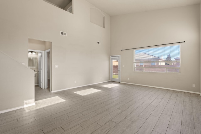 empty room featuring a towering ceiling