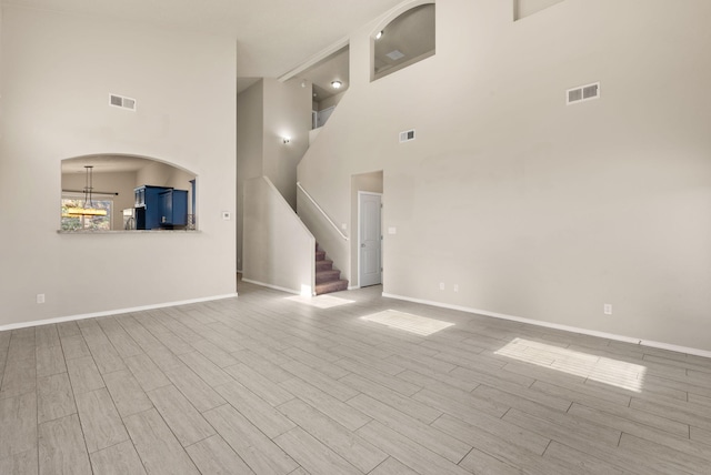 unfurnished living room with a high ceiling