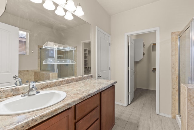 bathroom with vanity and a shower with shower door