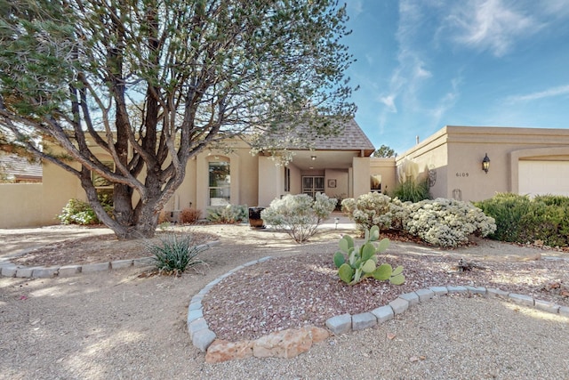 pueblo revival-style home with a garage