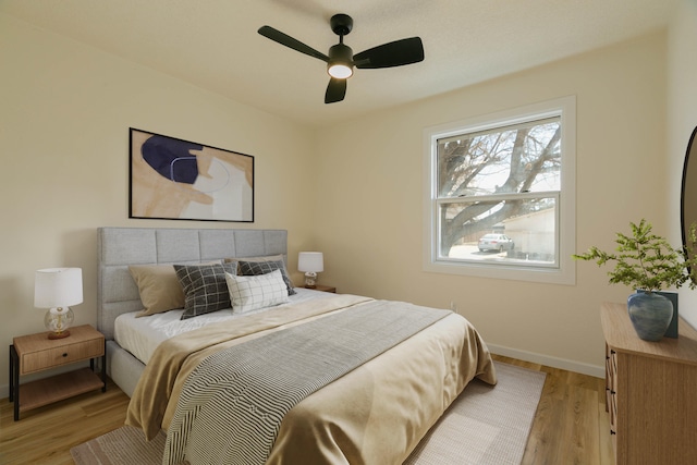 bedroom with ceiling fan and light wood-type flooring