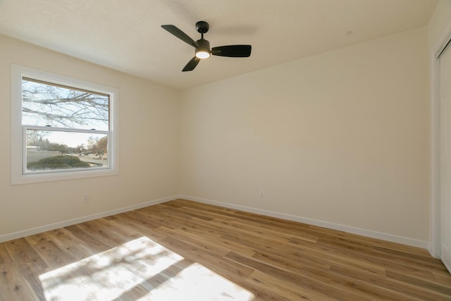 spare room with ceiling fan and light hardwood / wood-style flooring