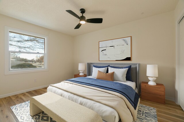 bedroom featuring hardwood / wood-style flooring and ceiling fan