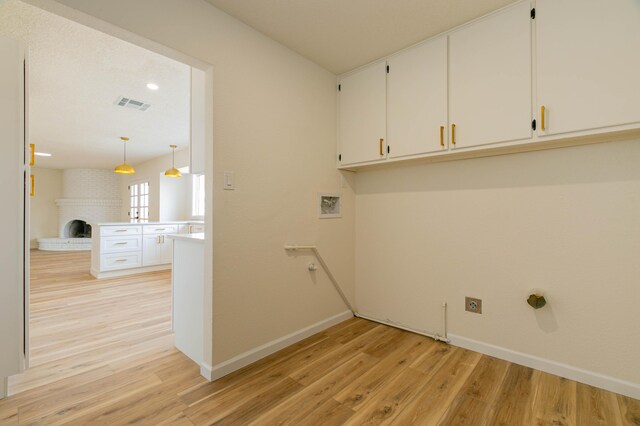 kitchen with pendant lighting, white cabinetry, kitchen peninsula, and dishwasher