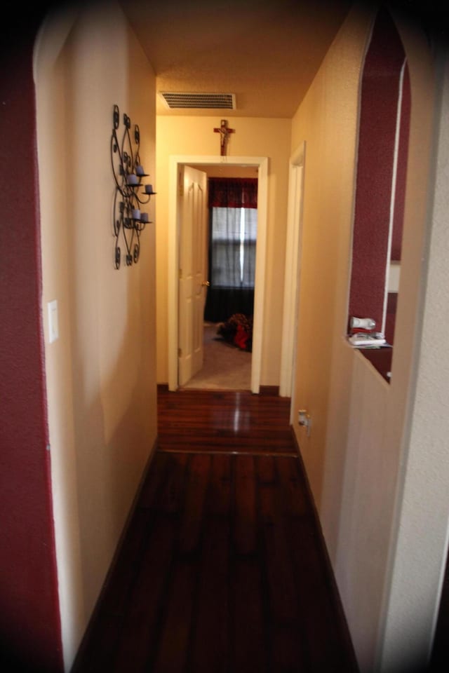 hall with dark wood-type flooring