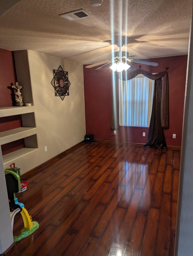 empty room with dark wood-type flooring and ceiling fan