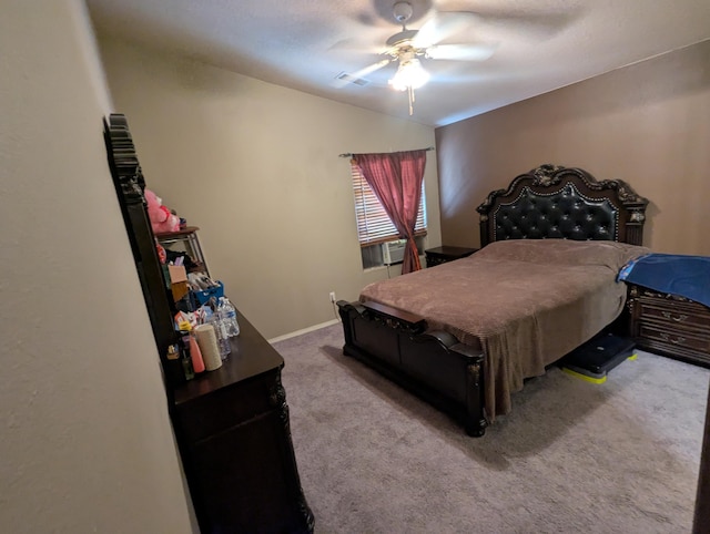 bedroom with cooling unit, light colored carpet, and ceiling fan