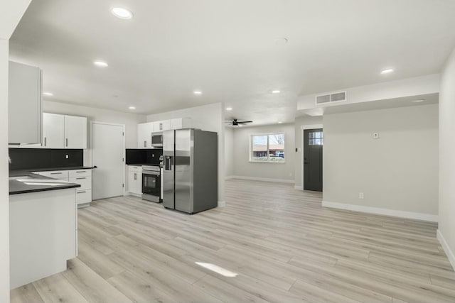 kitchen featuring stainless steel appliances, ceiling fan, light hardwood / wood-style flooring, white cabinetry, and tasteful backsplash