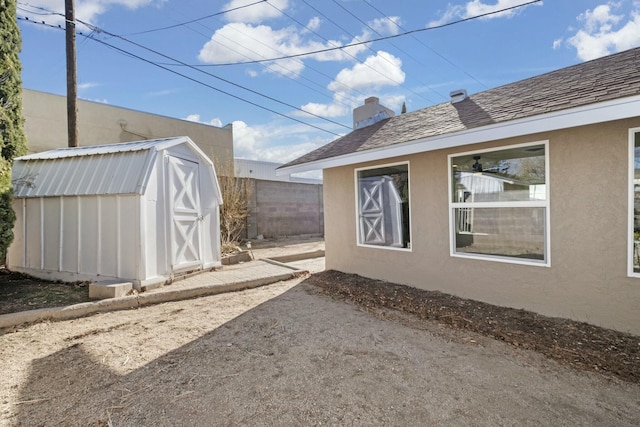 view of home's exterior featuring a shed