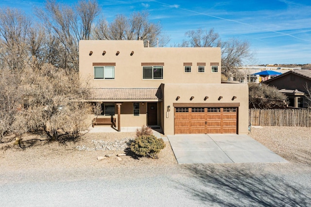 pueblo-style house with a garage