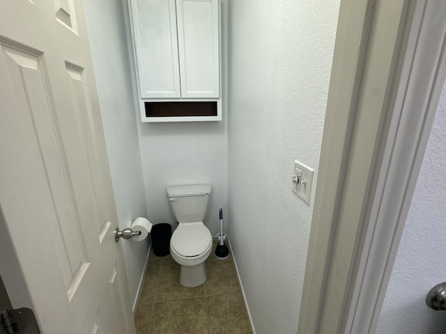 bathroom with tile patterned flooring and toilet