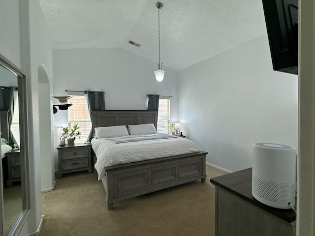 bedroom featuring a textured ceiling, carpet, and lofted ceiling