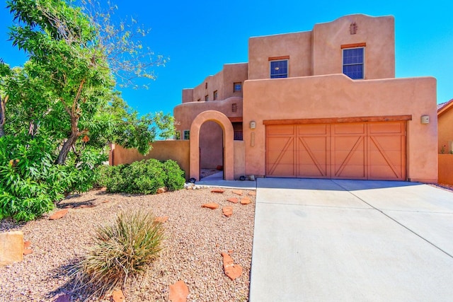 pueblo-style house with a garage