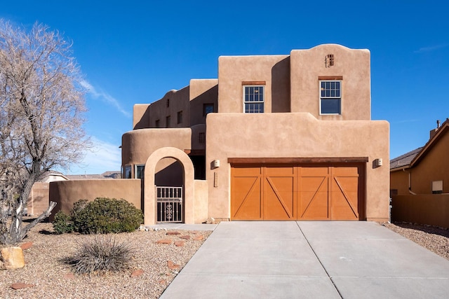 pueblo-style home with a garage