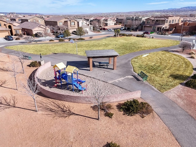 surrounding community featuring a playground and a lawn