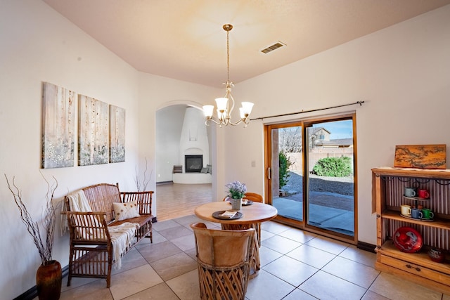 living room with light tile patterned floors and an inviting chandelier