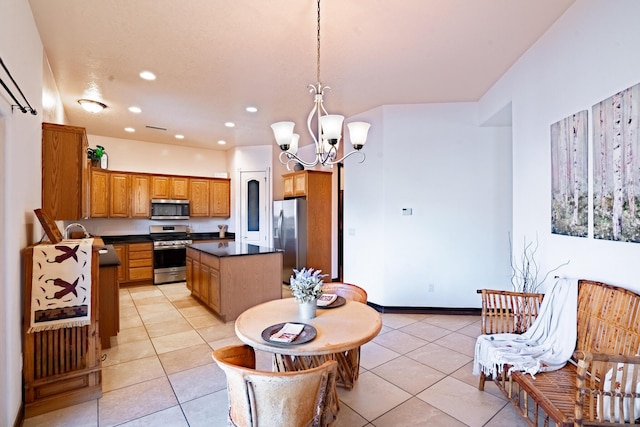 kitchen with a chandelier, light tile patterned floors, pendant lighting, and appliances with stainless steel finishes