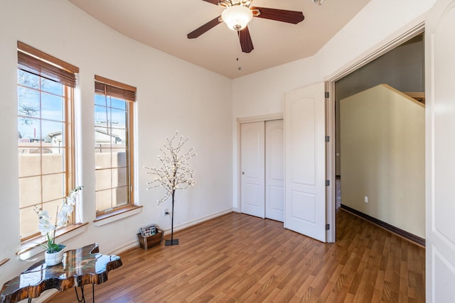 unfurnished bedroom with ceiling fan, dark hardwood / wood-style floors, and a closet